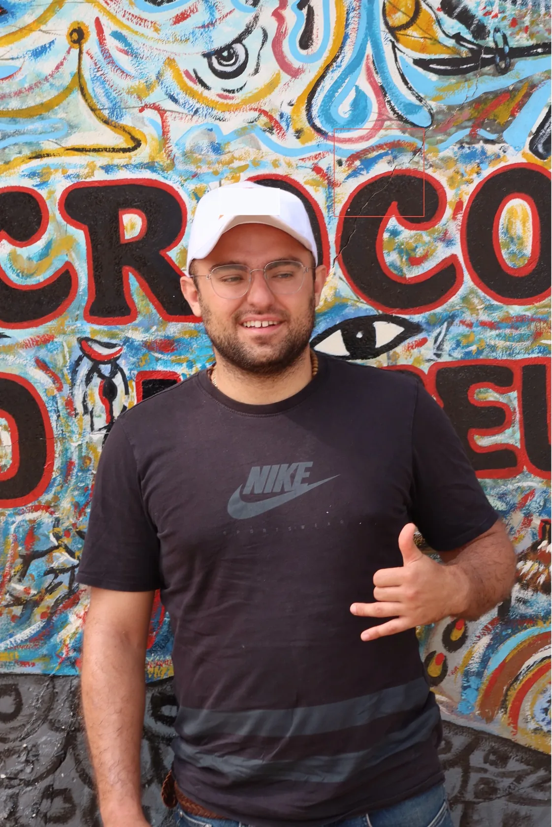 Matteo Arellano in front of a colorful mural